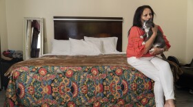 In this Wednesday, June 30, 2021, photo Veronica Perez poses at her new home at the Mollie Mason Project Homekey site in Los Angeles.