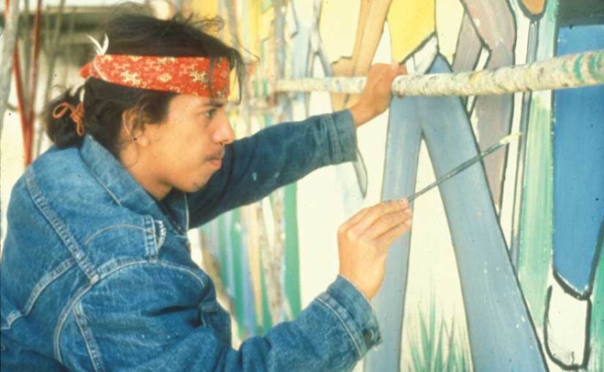 An undated photograph that is part of Bob Dominguez's book, "La Tierra Mia," depicts mural painting in Chicano Park in the early '70s. The photograph was contributed to the collection by muralist Victor Ochoa.