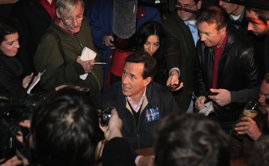 Republican presidential candidate and former U.S. Senator Rick Santorum is mobbed by press on Dec. 30 in Ames, Iowa.