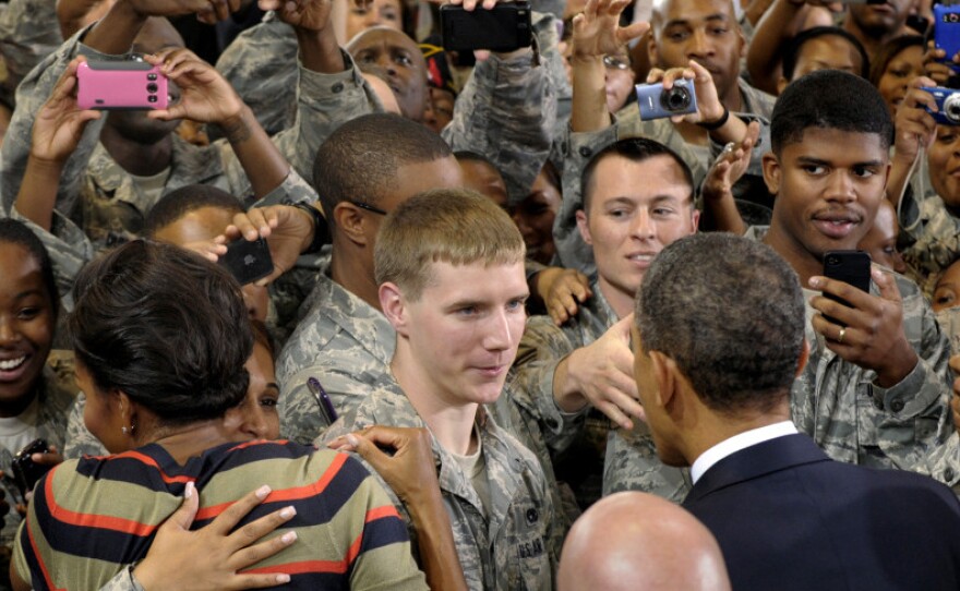 President Obama and first lady Michelle Obama meet troops during a stop at Joint Base Langley-Eustis in Hampton, Va, on Oct. 19. Obama says service members who fought for their country shouldn't have to fight for jobs when they come home.