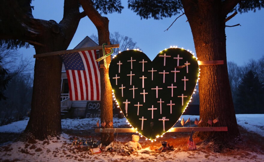 A makeshift memorial with crosses for the victims of the Sandy Hook Elementary School shooting massacre stands outside a home in Newtown, Conn., in December of 2013, the one-year anniversary of the shootings.