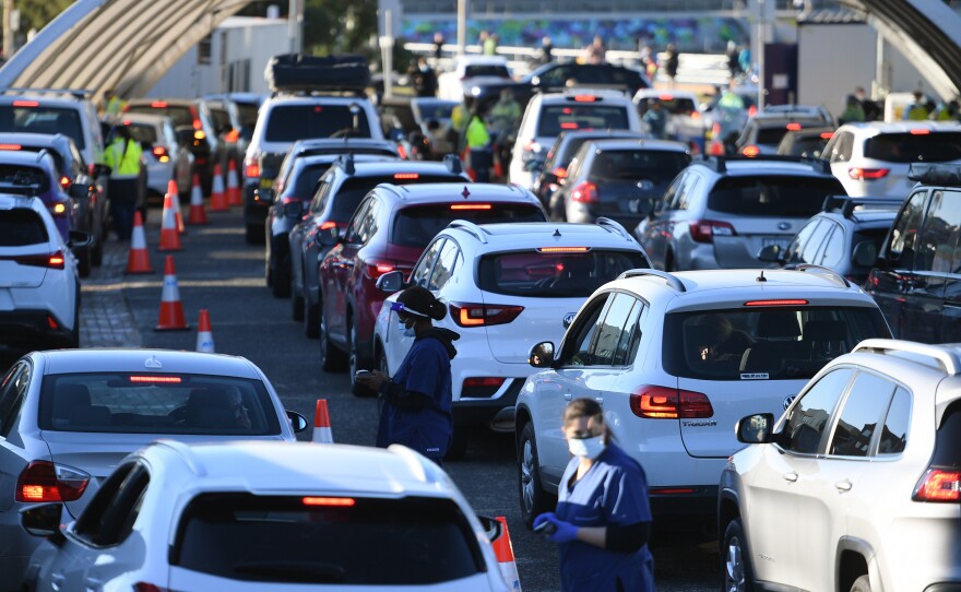 People line up in their cars to get tested for COVID-19 at a pop-up testing clinic at Bondi Beach in Sydney on June 25. Parts of Sydney will go into lockdown late Friday after a coronavirus outbreak in Australia's largest city continued to grow.