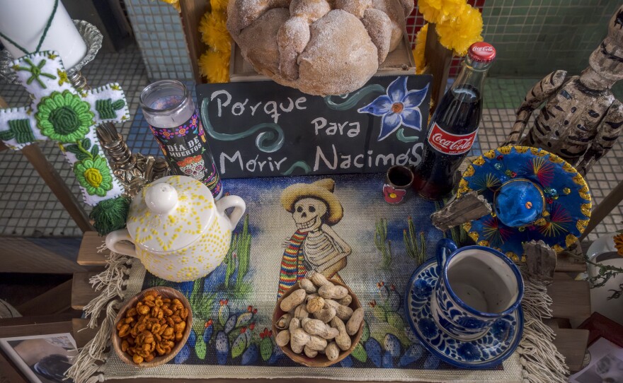 This small offering of chili powder coated peanuts, Coca Cola, pan de muerto, water and a sign saying “porque para morir nacimos” or “because we were born to die” decorates this altar at the Sherman Heights Community Center for Día de Muertos, Oct. 15, 2024.