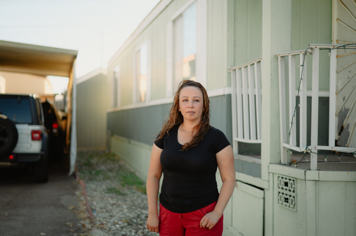 Ana Ramirez stands for a portrait outside her home at Brentwood Mobile Home Park in Chula Vista, California on Oct. 3, 2023. Ramirez, a parent of three kids, is paying close attention to the future of Harborside park.