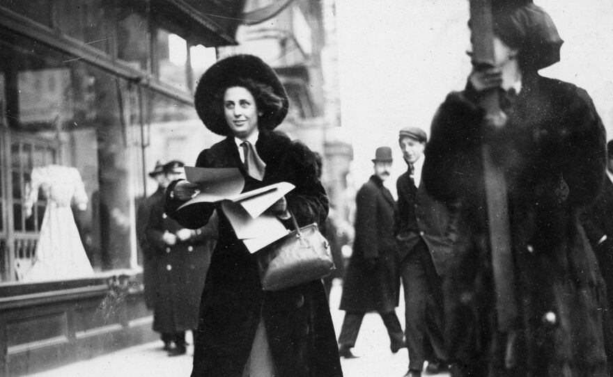 Martha Gruening, a suffragist leader, distributes literature on the Women's Suffrage Movement to passersby in New York City, circa 1912. She later earned a law degree from New York University and was active in the civil rights movement.