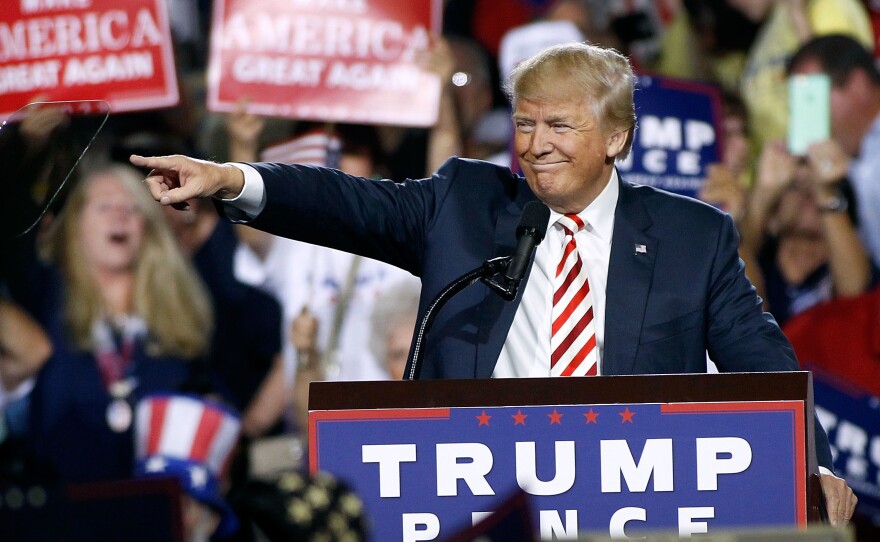 Republican presidential nominee Donald Trump points out to the crowd of supporters as he arrives at a campaign rally on Oct. 4, 2016 in Prescott Valley, Arizona.