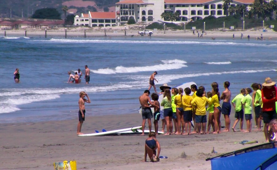 Children getting ready for a surfing lesson on Coronado's Central Beach, July 12, 2022.