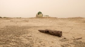 Photo of a 50mm round casing in the desert area that was previously the Mesopotamian Marshes, once the richest wildlife habitat in the Middle East. In the early 1990s, Saddam Hussein destroyed the Mesopotamian Marshes when its inhabitants rebelled against him.