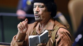 Libyan leader Moammar Gadhafi holds a copy of the U.N. charter, which he ripped slightly in protest, during his rambling speech to the General Assembly at United Nations headquarters Wednesday in New York.