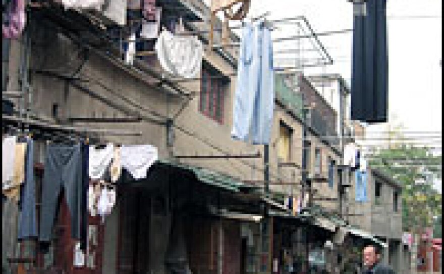 Red banners encouraging residents to move out as soon as possible festoon the alleys.