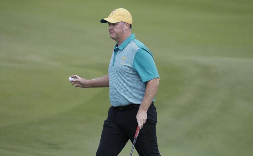 Marcus Fraser of Australia chips to the 16th hole during the first round of golf at the Olympics. Fraser shot a 63 to take a three-stroke lead. Thursday's play marked the return of golf to the games after a 112-year absence.