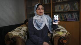 Hind Rajab poses in Gaza City, Wednesday, Aug. 19, 2026, with a photo of her granddaughter, Hind Rajab, a 5-year-old Palestinian girl who was killed alongside her family in Gaza in February 2024.