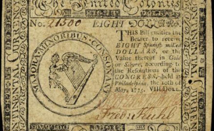 Image of an $8 Continental Currency paper note issued by the Continental Congress to finance the Revolutionary War, or the American Revolution. After gaining independence the U.S. adopted the dollar as its national currency.