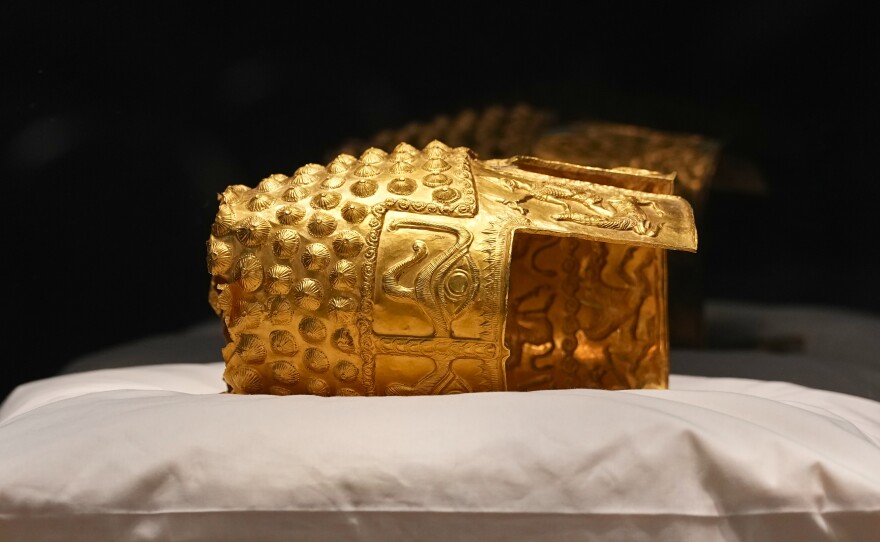 Dacian gold items, a 2,500-year-old helmet and wristbands, stolen from a museum in the Netherlands and then recovered by Dutch authorities, are presented during a press conference after being returned, at the National Museum of Romanian History, in Bucharest, Romania, Tuesday, April 21, 2026.