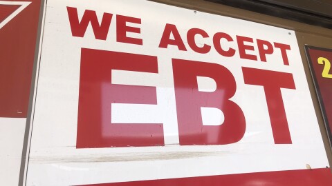 An sign displaying "We Accept EBT" is hung outside of a store in City Heights, in this undated photo.