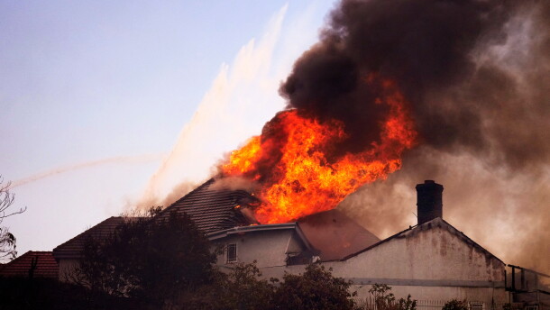 A roof engulfed in flames is seen during the Norte Fire on Friday, Oct. 16, 2026, in San Juan Capistrano, Calif.