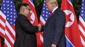 U.S. President Donald Trump shakes hands with North Korea leader Kim Jong Un at the Capella resort on Sentosa Island Tuesday, June 12, 2018. 
