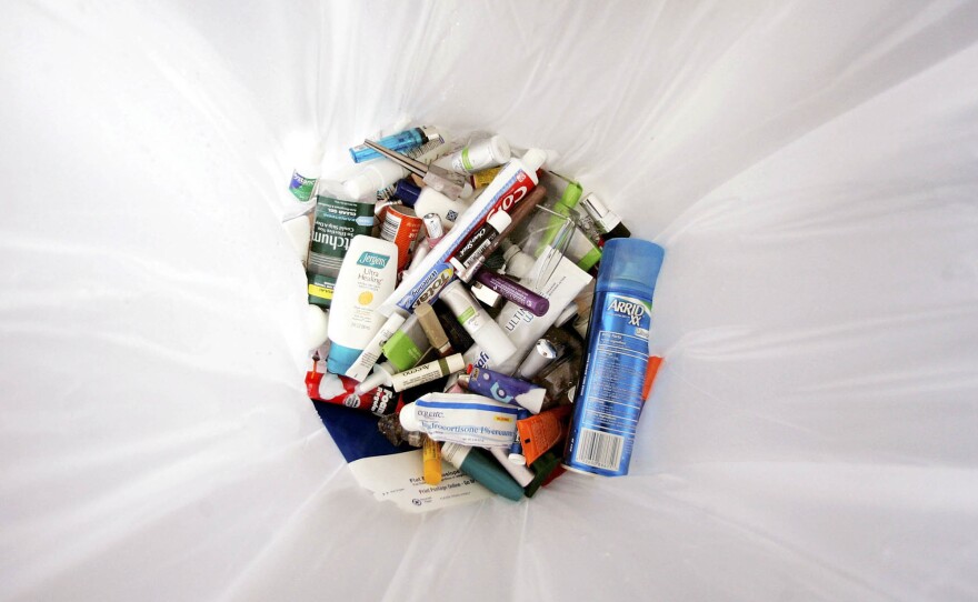 Containers holding liquids and gels that were taken from passengers lie in a trash can at Dulles International Airport near Washington, D.C., on Aug. 10, 2006.