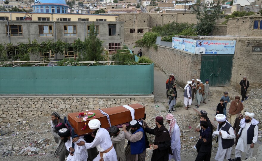 Mourners carry the body of a victim of a mosque bombing in Kabul, Afghanistan, Thursday, Aug. 18. 2022.