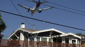 A jetliner flies over a home on Third Avenue near downtown San Diego that was recently renovated with $72,000 worth of new windows, doors and ventilation systems to lesson the noise of airplane traffic, Feb. 26, 2015.