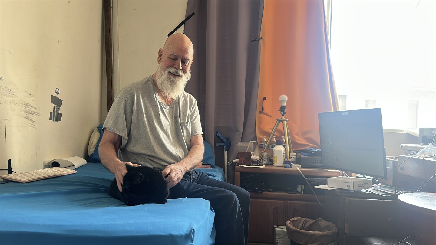 Disabled vet Michael Davis is shown with his cat, Angel on Feb. 26, 2025.