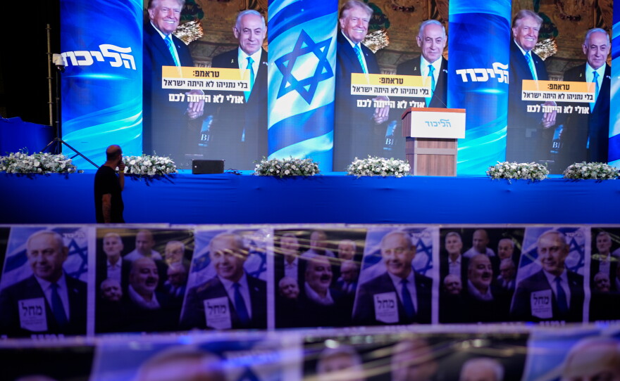 A video wall displays images of Benjamin Netanyahu with President Trump at a Likud party event before the release of the first exit poll results in Israel's general election, in Jerusalem, on Tuesday.
