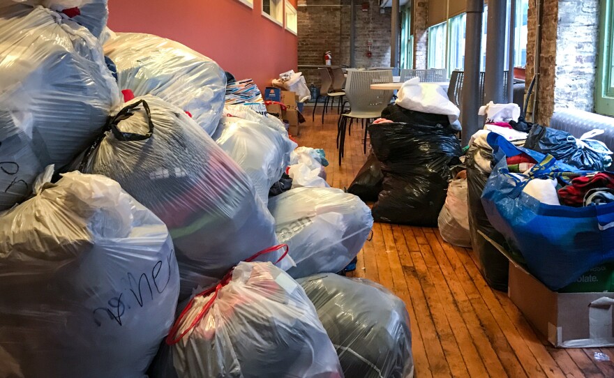 Plastic bags filled with clothing donations pile up in the hallways of the Nationalities Service Center, which has seen an uptick in donations for refugees and other immigrants since Trump's election.