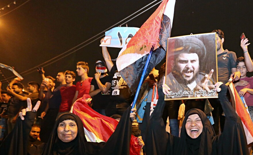 With official results in from just over half of the country's provinces, supporters of current frontrunner, the influential Shiite cleric Muqtada al-Sadr, celebrate in Tahrir Square, Baghdad, early Monday.