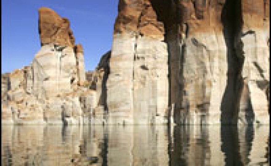 A bleached "bathtub ring," the result of a six-year drought that has dramatically dropped the level of the reservoir, shows on red Navajo sandstone formations near Last Chance Bay at Lake Powell.