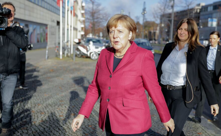 German Chancellor Angela Merkel arrives at her Berlin party headquarters Friday for talks with members of potential coalition parties to form a new government.