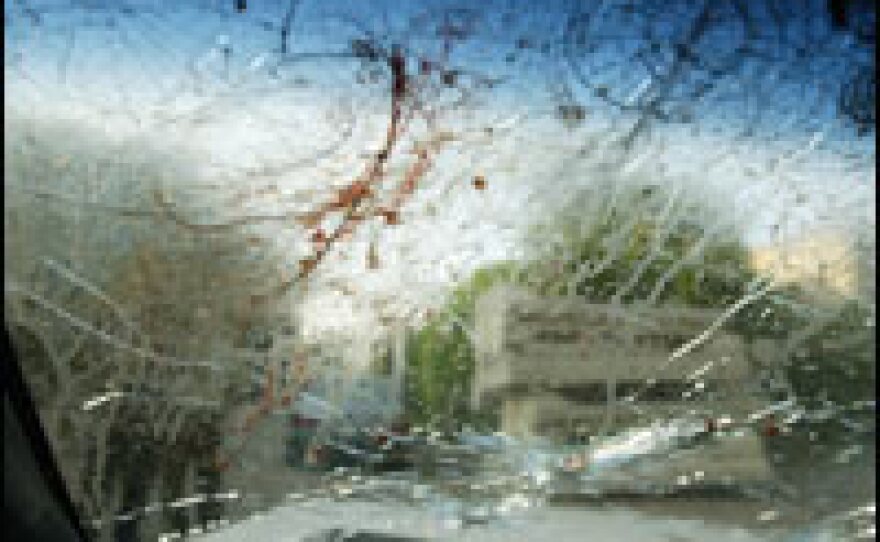 The bullet-riddled windscreen of a car that was carrying two women who were allegedly shot dead by private security guards.