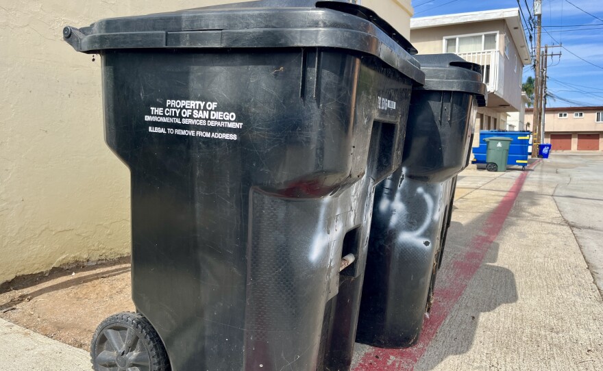 Trash bins stand in an alley in Ocean Beach, Sept. 17, 2025.