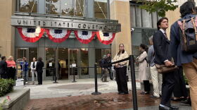 People line up outside the Oakland, California federal courthouse ahead of opening arguments in the trial that four state attorneys general are bringing against Meta Platforms, Inc.