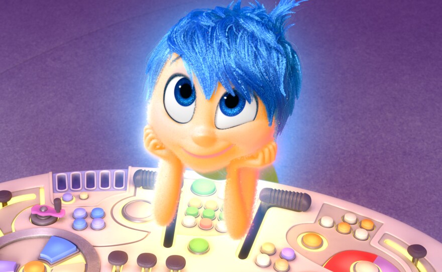 A range of emotions, including Joy (above), take turns controlling a console in 11-year-old Riley's head in the Disney/Pixar film <em>Inside Out.</em>