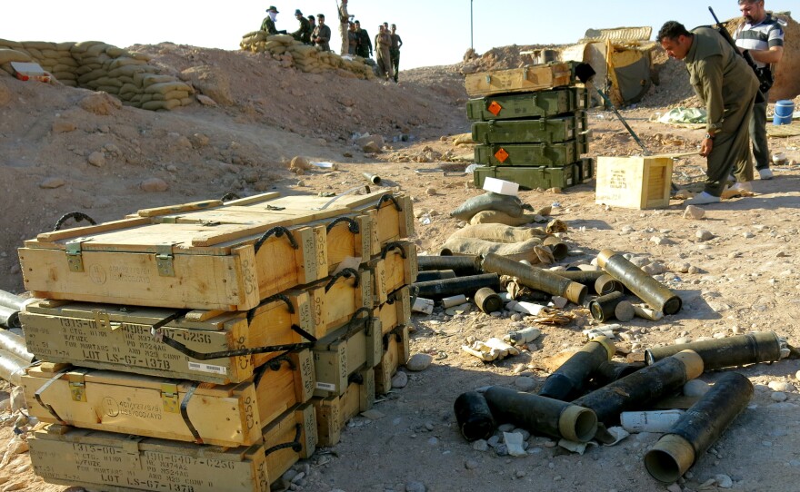 Peshmerga discuss how to respond to the approach of ISIS fighters from an outpost near the front lines.