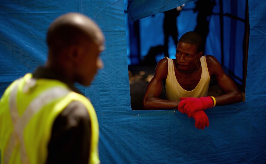 Aid workers with the nonprofit Partners In Health say there's no time to build Ebola clinics from scratch. So the agency is transforming an existing holding center into a treatment facility with a high standard of care.