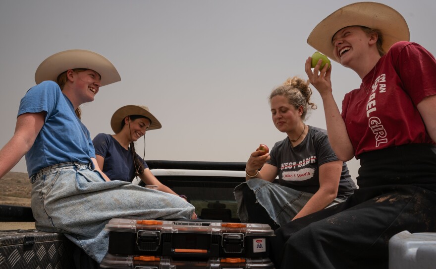 (L-R) Katie Hutsler, Zandri , Tessa Waller and Payton, members of Evangelical group HaYovel take care of trees they planted earlier in the year outside if the Israeli settlement of Gitit on April 18, 2024.
