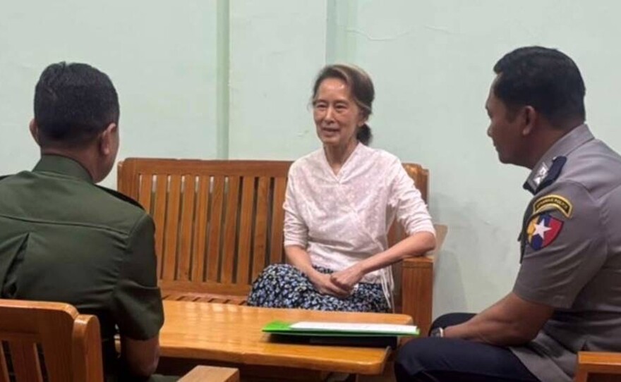 In this undated photo provided on April 30, 2026, by the Myanmar Military True News Information Team, the country's former leader Aung San Suu Kyi, center, talks with officials in an undisclosed location in Myanmar.