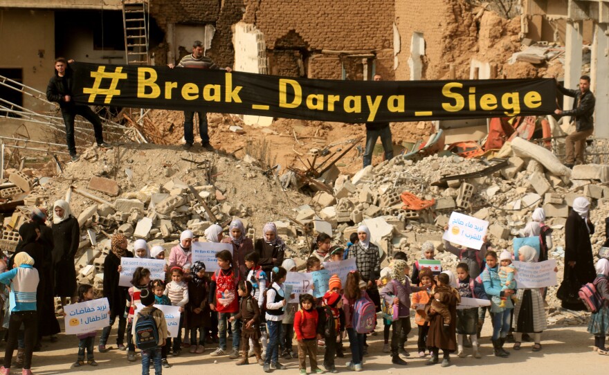 Syrian women and children stage a protest against the government's siege of Daraya, outside Damascus, on March 9. The protesters demanded that President Bashar Assad's government allow humanitarian aid into the city.
