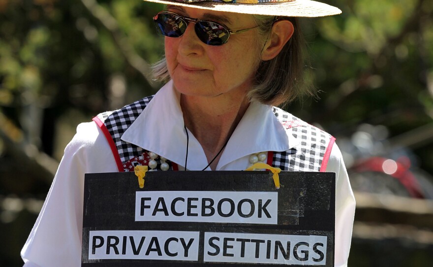 Mary Guedon of the group Raging Grannies holds a sign as she protests in 2010 outside of the Facebook headquarters in California. Privacy advocates say it's too difficult to fully protect your privacy on Facebook.