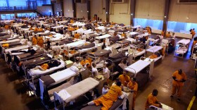 The upcoming prisoner release is meant to reduce costs — California spends almost 10 percent of its general fund budget to house inmates. Above, the gymnasium at San Quentin, seen in a 2009 file photo, serves as overflow housing for hundreds of inmates.