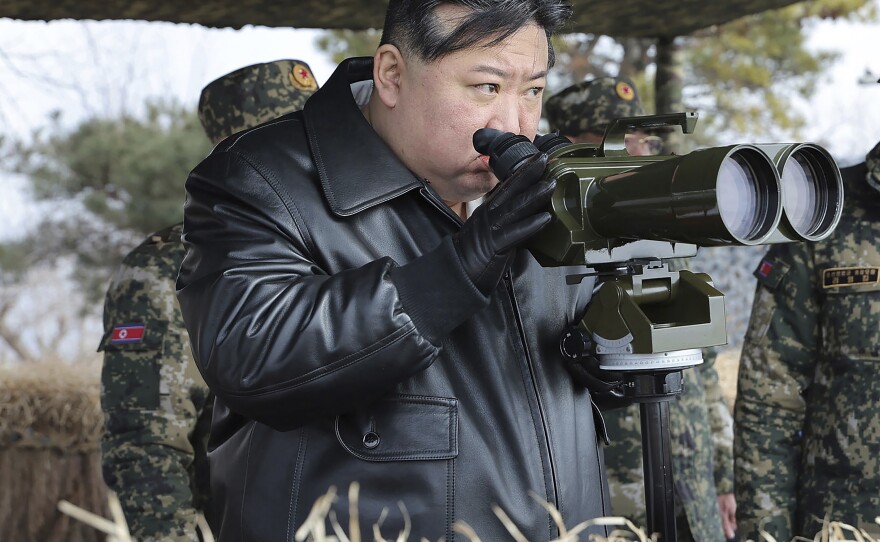In this photo provided by the North Korean government, North Korean leader Kim Jong Un, left, supervises artillery firing drills in North Korea Thursday, March 7, 2024.