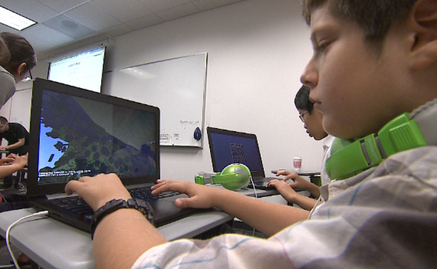 Stanley Strum shows off some of the mods he's created in Minecraft, Sept. 20, 2014.