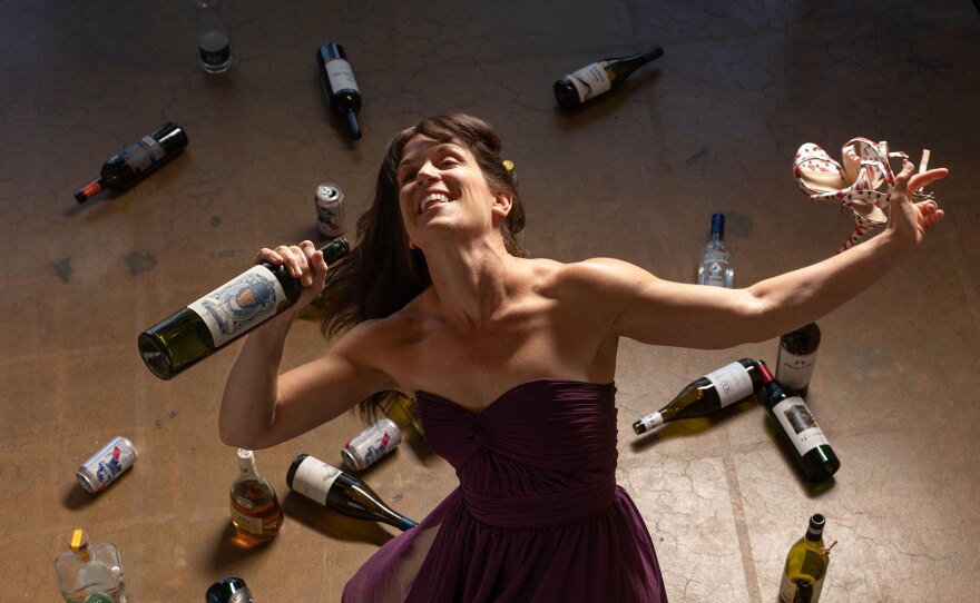 Dancer Erica Buechner is shown in a dramatized scene with bottles and cans to promote "Sauced," a dance performance at Art Produce June 30 through July 2, 2022.