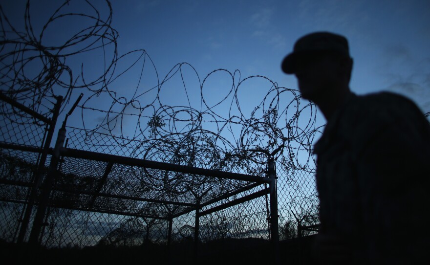 A Public Affairs Officer escorts media through Camp X-Ray, the first detention facility to hold "enemy combatants" at the U.S. Naval Station in Guantanamo Bay, Cuba.