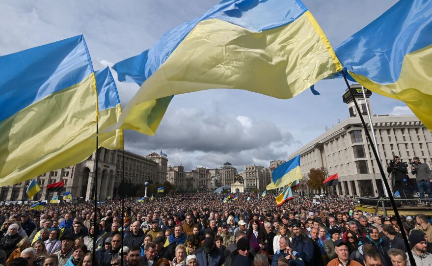 Demonstrators wave Ukraine national flags as they gather in central Kyiv on Oct. 6, 2019, to protest broader autonomy for separatist territories, part of a plan to end a war with Russian-backed fighters. Protesters chanted "No to surrender!", with some holding placards critical of President Volodymyr Zelenskyy in the crowd, which police said had swelled to around 10,000 people.
