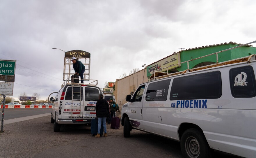 Drivers for the transportation service, Transporte Directo, pack up vans of people traveling from the U.S.-Mexico border in Douglas, Ariz., to Tucson and Phoenix.