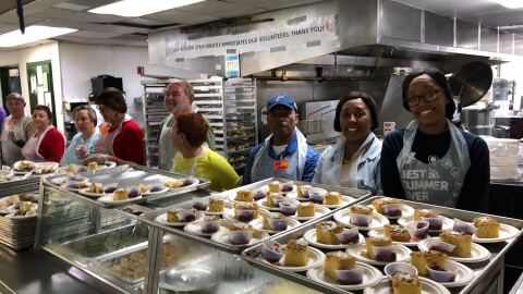 Volunteers prepare to serve food for the Christmas Eve lunch at Father Joe's Villages in downtown San Diego,  Dec. 24, 2019.