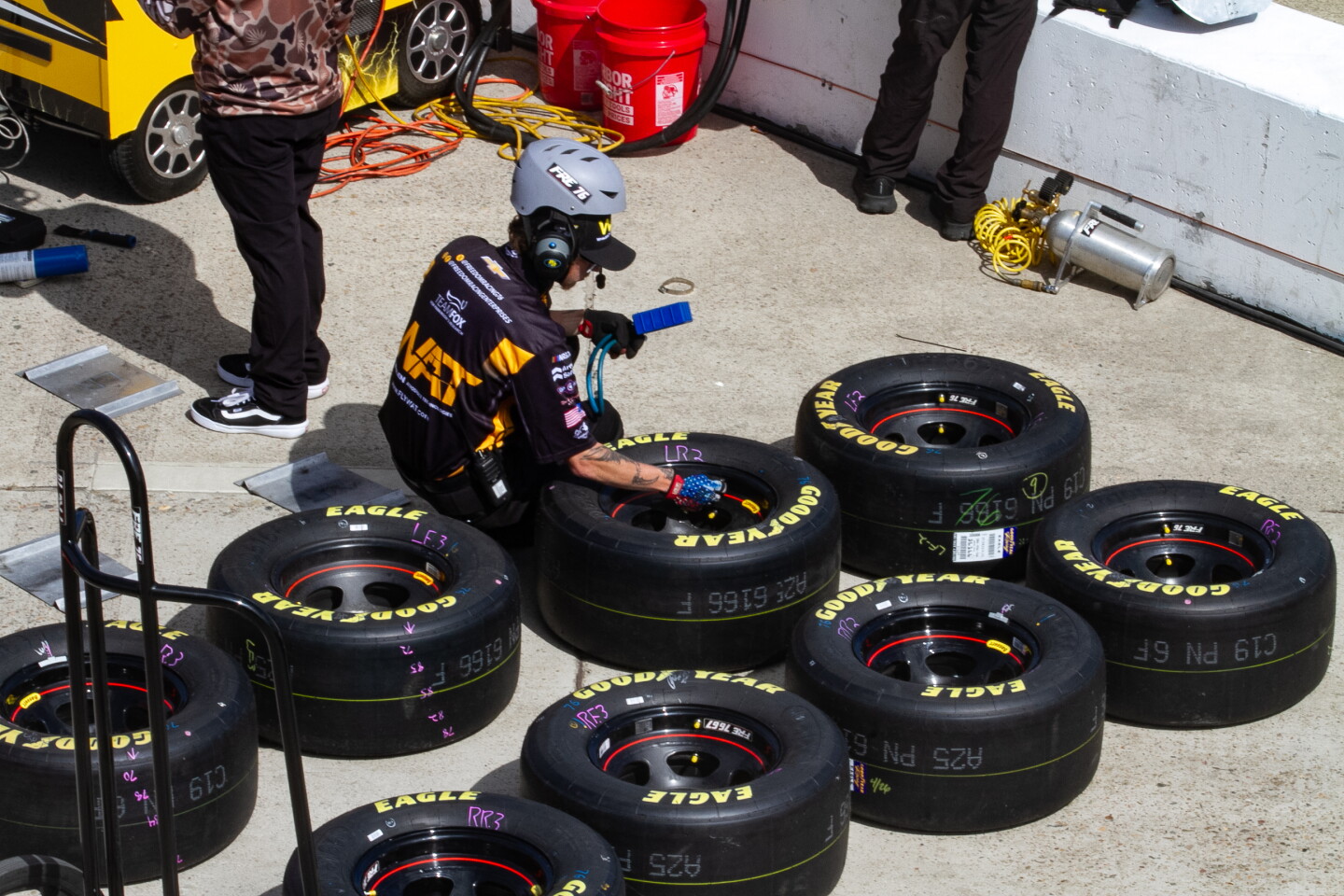 Man checks tire pressure at NASCAR San Diego Weekend presented by Anduril at Naval Base Coronado on June 19, 2026.
