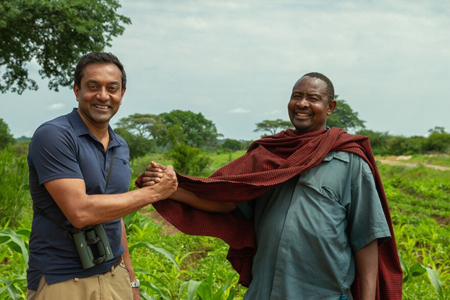 Meeting the locals, M. Sanjayan and a village chief discuss how humans can live side by side with wildlife. Tanzania, Africa.